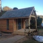 Delabole Slate Roof and Larch Timber Cladding on New Self Build Summerhouse in Devon by Carpenter Oak Ltd