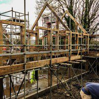 Side elveation view of a self build oak frame with scaffolding