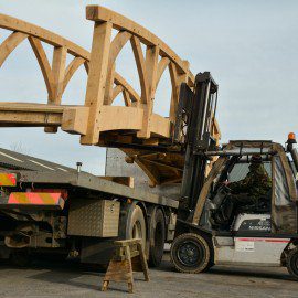 long shot of oak garden bridge being moved with a forklift truck