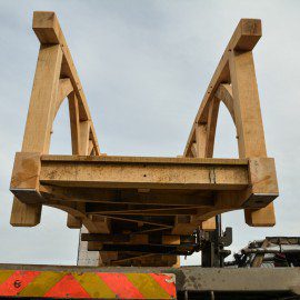 looking up at oak garden bridge being moved with a forklift truck