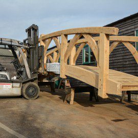 oak garden bridge being moved with a forklift truck