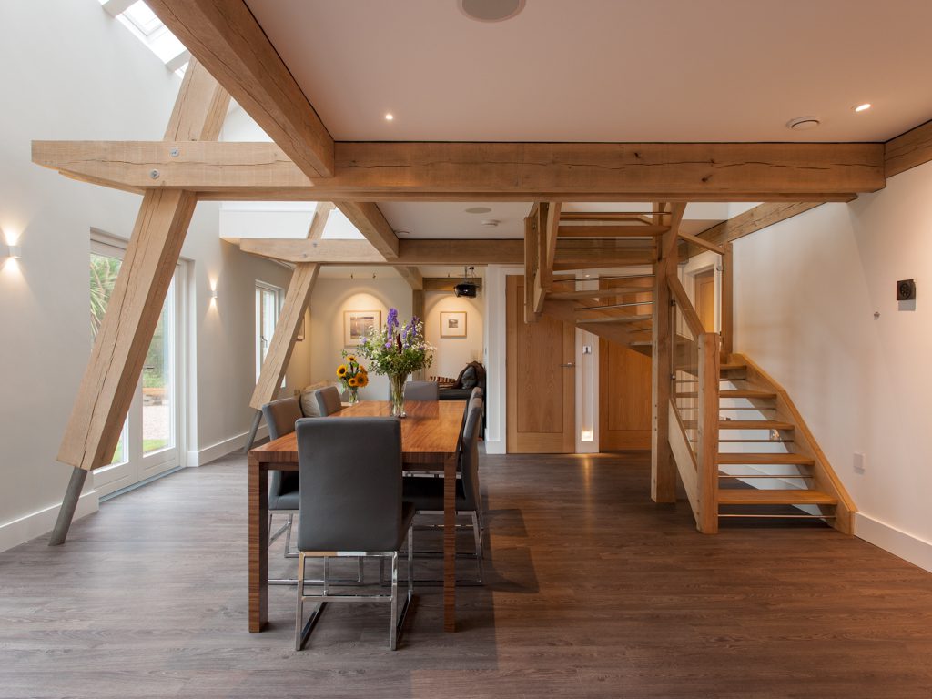 Oak framed living area - timber frame houses by Carpenter Oak Ltd
